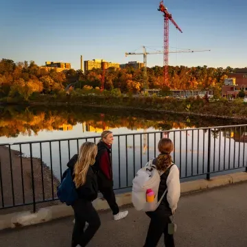 students on footbridge, fall scene 